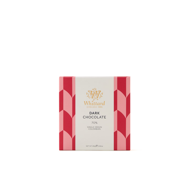 A box of Whittard Chelsea 1886 Dark Chocolate 70%, featuring a white and pink geometric design with gold text on the front, set against a plain white background.
