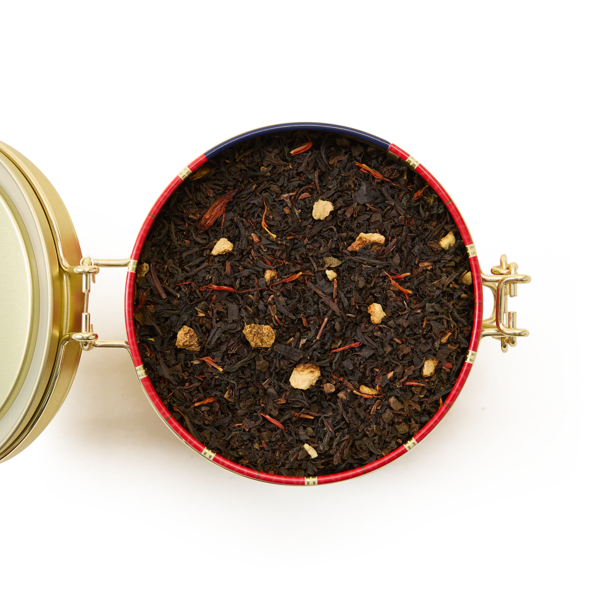 A round Christmas Tea Clip Top Tin with a gold hinged lid, filled with loose leaf black tea blended with small dried fruit and flower pieces, viewed from above on a white background.