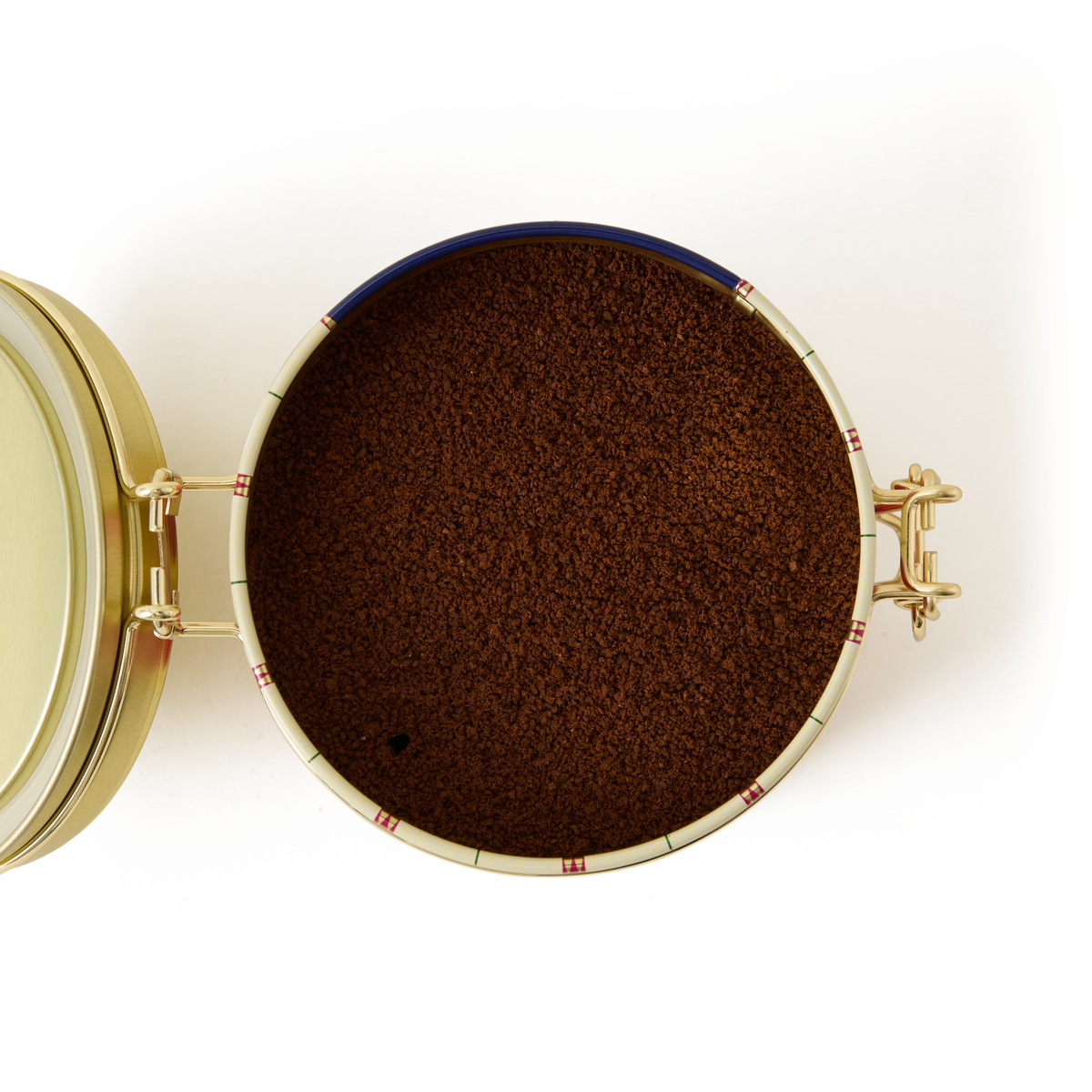 An open Christmas Coffee Clip Top Tin filled with finely ground festive coffee, viewed from above with the lid open to the left and a metal latch securing the right side—a perfect choice for a thoughtful holiday coffee gift.