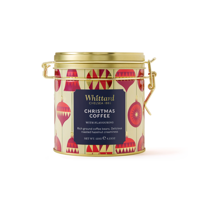 A gold Christmas Coffee Clip Top Tin by Whittard, adorned with red ornament designs and a secure clamp lid. The label highlights rich ground coffee infused with roasted hazelnut creaminess—an ideal festive blend and the perfect coffee gift for the holiday season.
