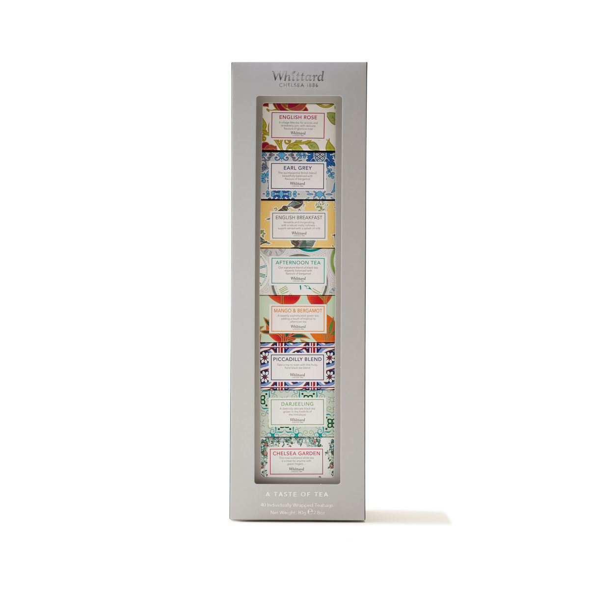 A boxed gift set, Tea Discoveries A Taste of Tea, featuring eight Whittard assorted teas in colorful, uniquely designed packaging, neatly displayed vertically in a silver frame labeled "A Taste of Tea.