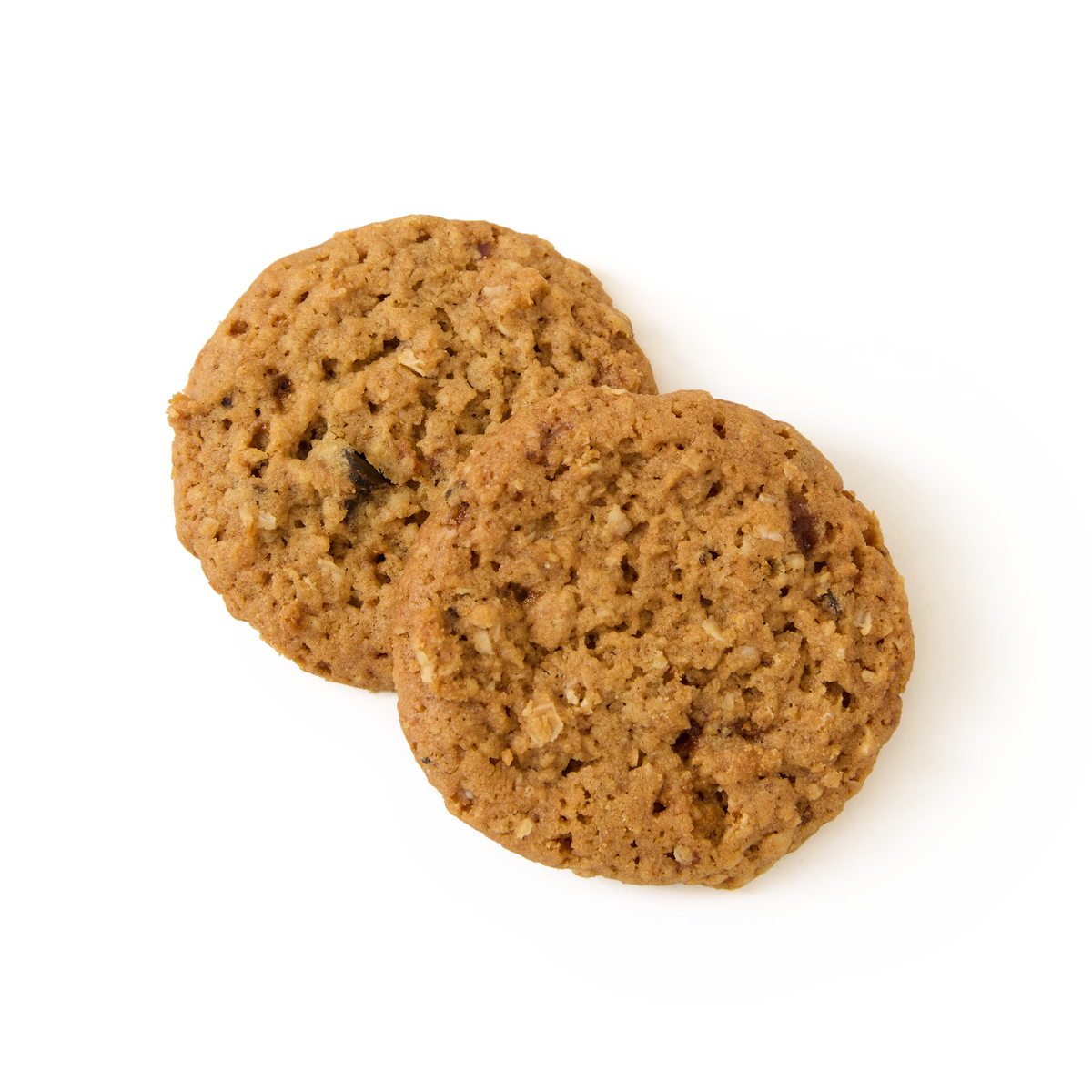 Two Sticky Toffee Pudding Biscuits with a slightly rough texture are overlapping each other on a plain white background, reminiscent of classic British biscuits enjoyed alongside traditional puddings.