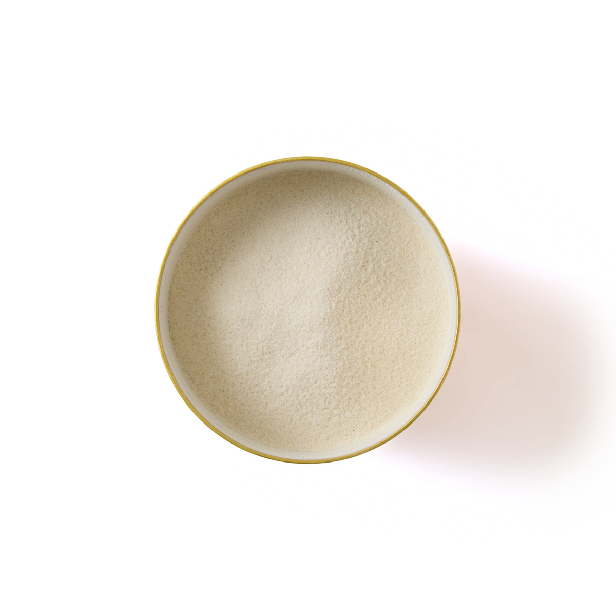 A round bowl filled with fine, off-white powder seen from above on a white background.