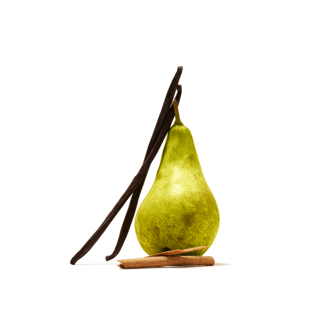A green pear stands upright with two vanilla beans leaning against it and a cinnamon stick lying in front, all set against a white background—an inviting scene that perfectly reflects the essence of our Spiced Pear Flavour Instant Tea, a limited edition blend inspired by autumn flavours.