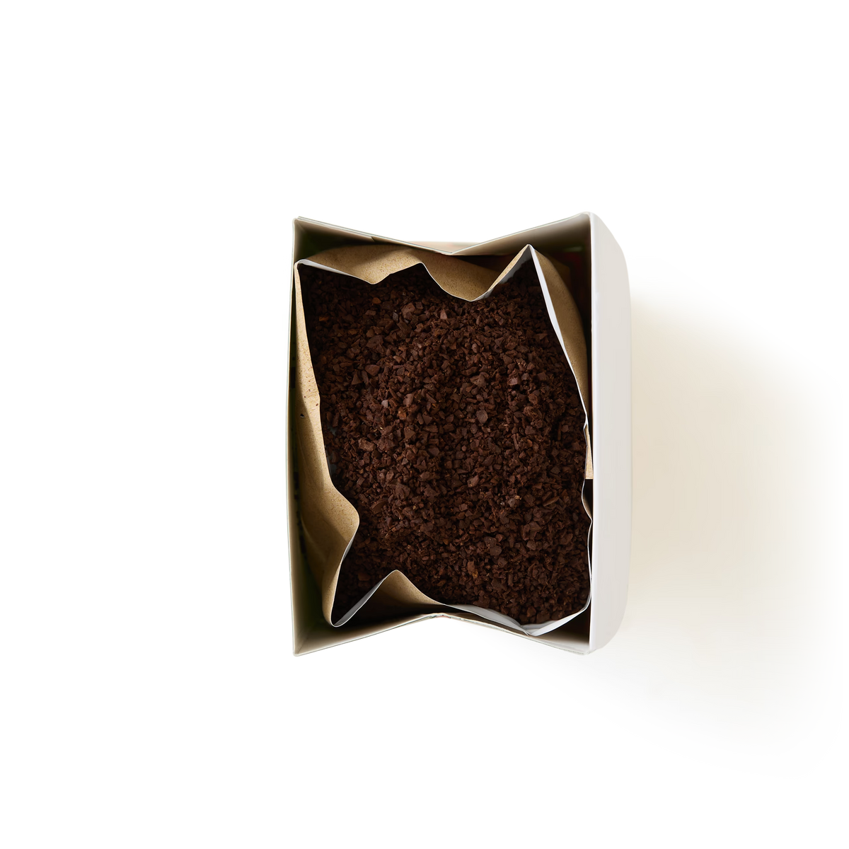 An open bag of Limited Edition Festive Coffee is viewed from above, revealing the dark brown coffee grounds inside a metallic-lined paper package set against a plain white background.