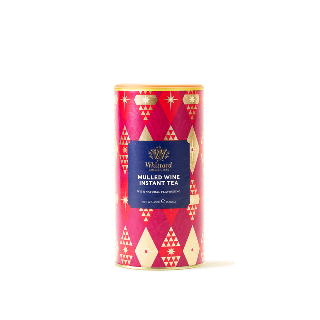 A cylindrical tin labeled Mulled Wine Instant Tea, featuring a red and gold geometric design, stands upright against a plain white background, offering a festive beverage that serves as an ideal non-alcoholic alternative to mulled wine.