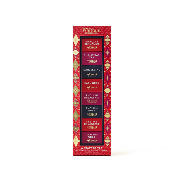 A festive red Whittard tea gift box featuring six flavors: Mango & Bergamot, Christmas, Darjeeling, Earl Grey, English Breakfast, and Festive Breakfast. Gold and purple holiday patterns decorate the packaging.