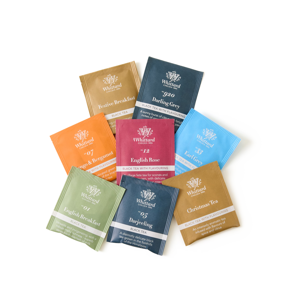 Nine colorful tea sachets from “A Feast of Tea” are arranged in a fan shape on a white surface, each featuring a different flavor—including English Rose, Earl Grey, and Christmas Tea—making this the perfect Christmas tea gift for tea lovers.
