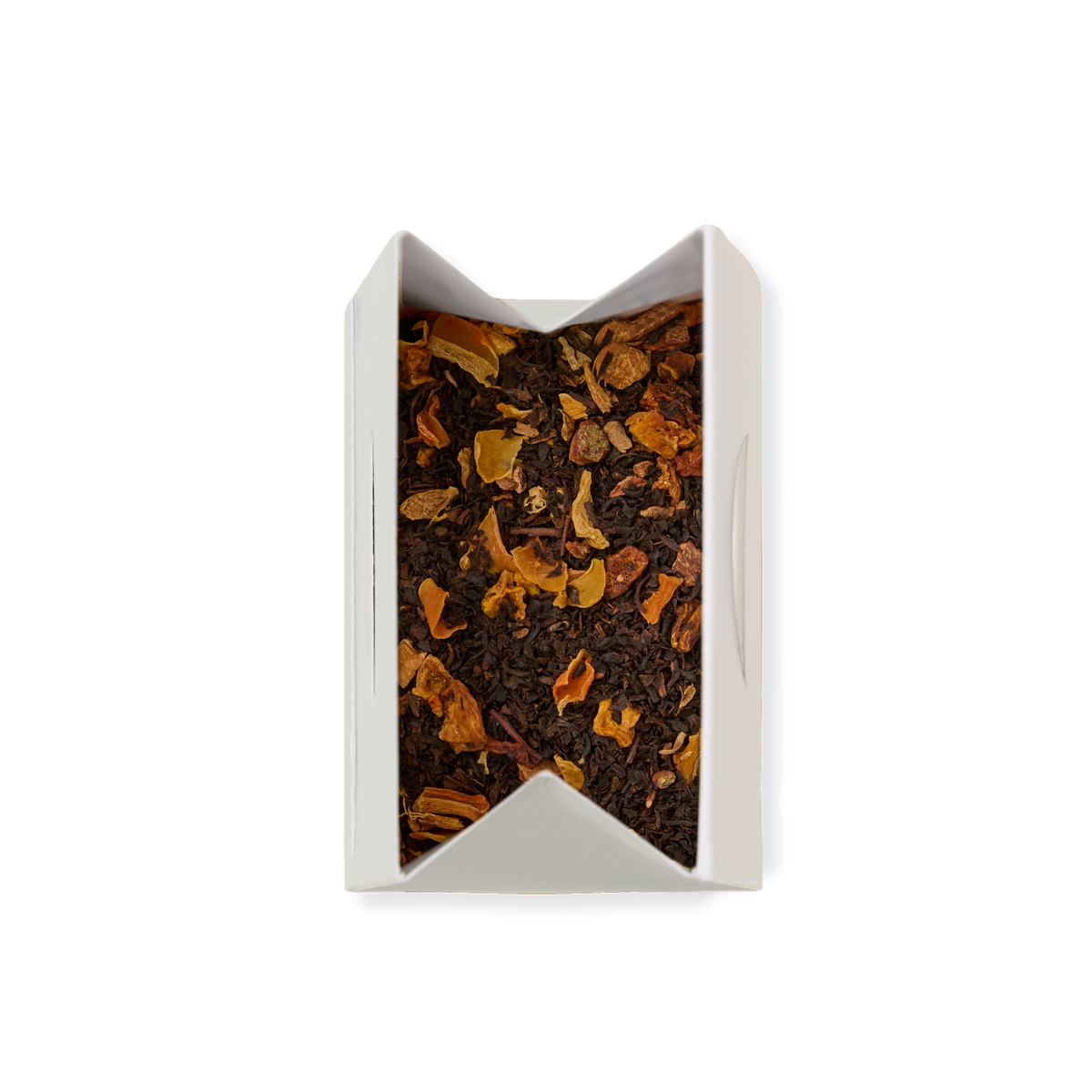 An open white pouch of POUCH SPICED PUMP CHAI 26 containing loose leaf chai with visible dried orange and brown fruit pieces, viewed from above on a white background.