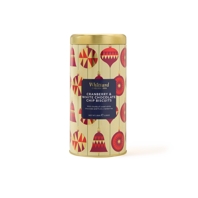 A cylindrical gift tin with a gold lid, decorated with red holiday ornaments. The label reads Cranberry & White Chocolate Biscuits—perfect festive biscuits for gifting. Net weight 150g.