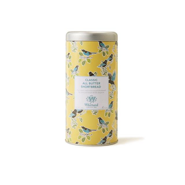 A yellow tin featuring bird and leaf illustrations, labeled Tea Discoveries Classic All Butter Shortbread Biscuit Tin by Whittard, sits against a plain white background—an inviting treat for any teatime biscuit lover in search of traditional British shortbread.