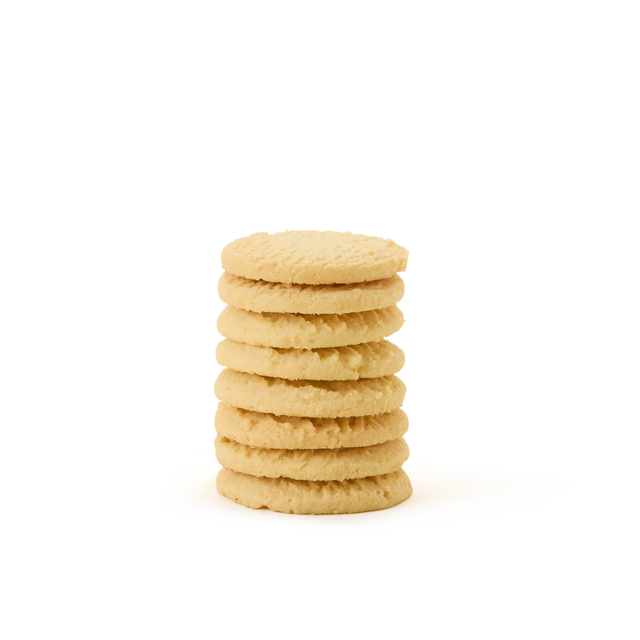 A stack of seven round, golden sugar cookies is arranged on a white, seamless background.