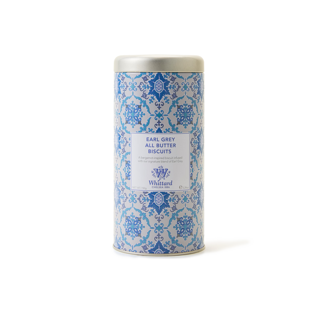 The Tea Discoveries Earl Grey All Butter Biscuit Tin from Whittard is a cylindrical container adorned with an elegant blue and white design, labeled accordingly. Featuring a silver lid, this tin holds delicate bergamot biscuits and makes an ideal tea gift, shown here against a plain white background.