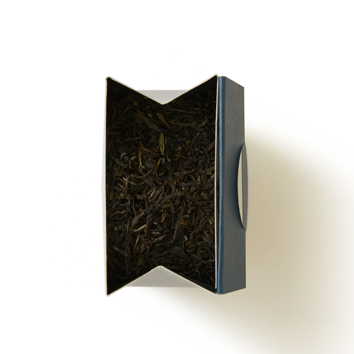 An open rectangular dark blue tin filled with loose-leaf Margaret’s Hope 2026 First Flush Darjeeling Single Estate Loose Leaf Tea.