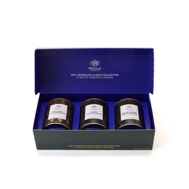 The Hot Chocolate Classic Collection features three tins of Whittard hot chocolate—Luxury Hot Chocolate, Salted Caramel, and 70% Cocoa Hot Chocolate—beautifully displayed in an open blue and black gift box.