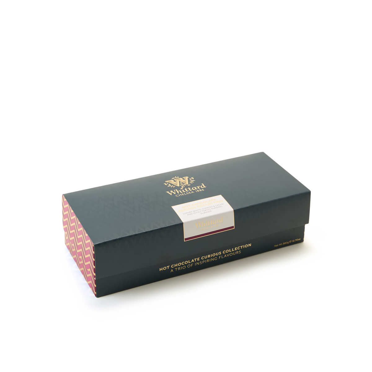 A rectangular Hot Chocolate Curious Collection gift box from Whittard, in dark green with gold lettering and patterned pink sides, featuring tempting flavors such as Cookies & Cream Hot Chocolate and Luxury White Hot Chocolate, is displayed against a plain white background.