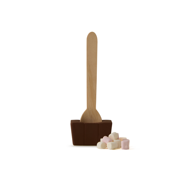 A Black Forest Flavour Chocolate Spoon, featuring a wooden stick embedded in a block of chocolate, is paired with a small pile of pastel-colored mini marshmallows, all set against a plain white background.