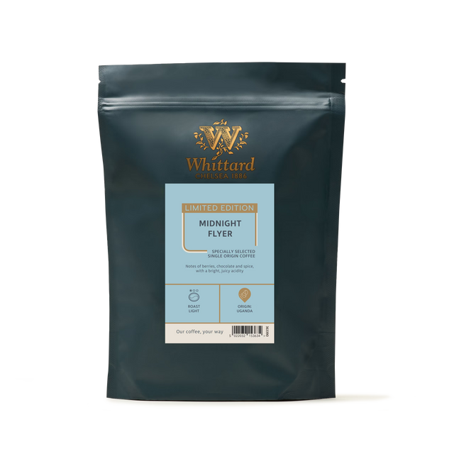 A dark grey stand-up pouch of Limited Edition Midnight Flyer Coffee with a light blue label featuring product details, tasting notes, and a roast level indicator.