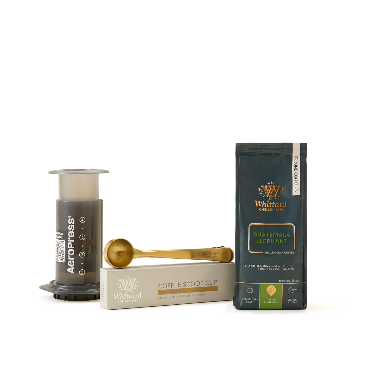 AeroPress Coffee Starter Kit featuring a gold Whittard coffee scoop clip and a bag of Whittard Guatemala Elephant coffee, all presented on a white background—everything you need for effortless coffee brewing.