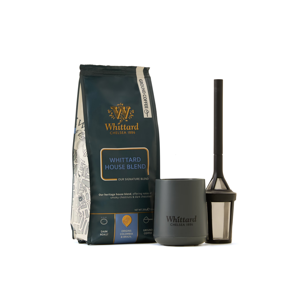 The Coffee Lovers Kit, featuring a Whittard House Blend coffee bag, a dark gray Whittard mug, and a black coffee press with mesh filter, all arranged on a white background—the ideal set for anyone who appreciates specialty coffee.