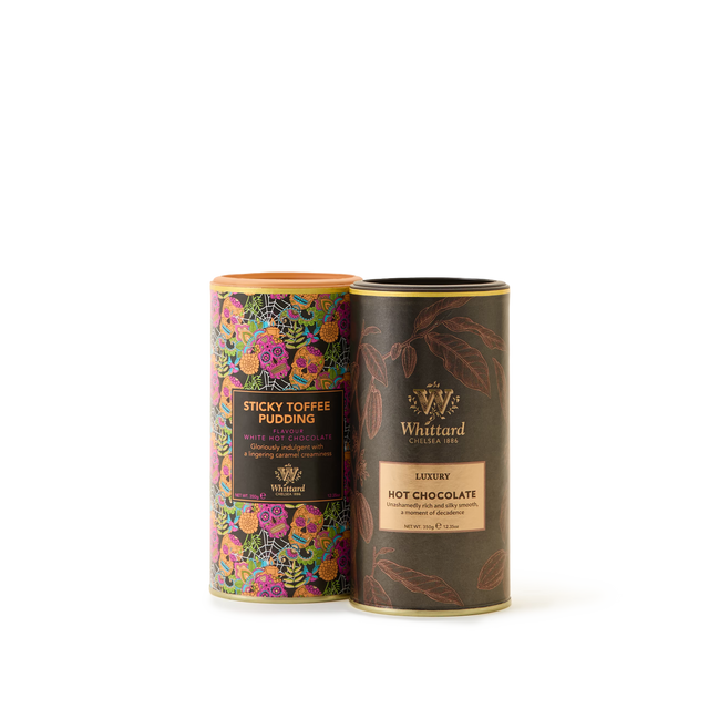 Two cylindrical Whittard tins—one featuring a vibrant floral design labeled Sticky Toffee Pudding Hot Chocolate, and the other a dark brown with gold accents labeled Luxury Hot Chocolate—stand side by side on a white background. The Delicious Hot Chocolate Duo Gift Box is perfect for anyone seeking a luxurious and thoughtful hot chocolate gift.