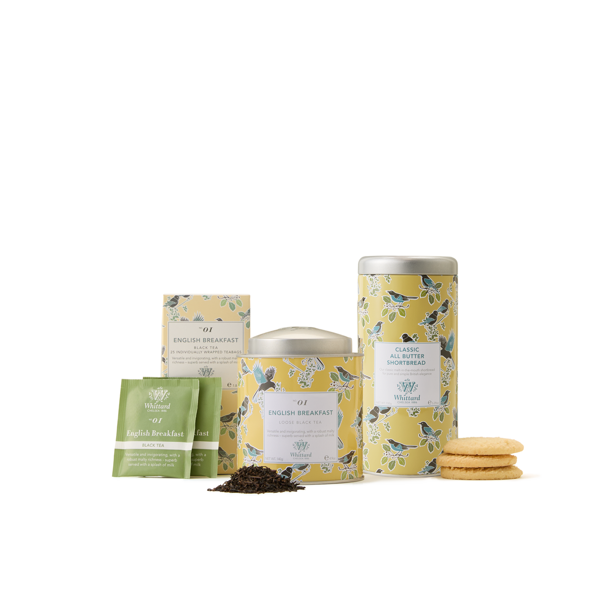 A delightful British tea gift, The English Breakfast Collection includes two tins, tea bags, a small pack, loose leaf English Breakfast tea, and a stack of cookies—each elegantly wrapped in yellow floral packaging on a white background.