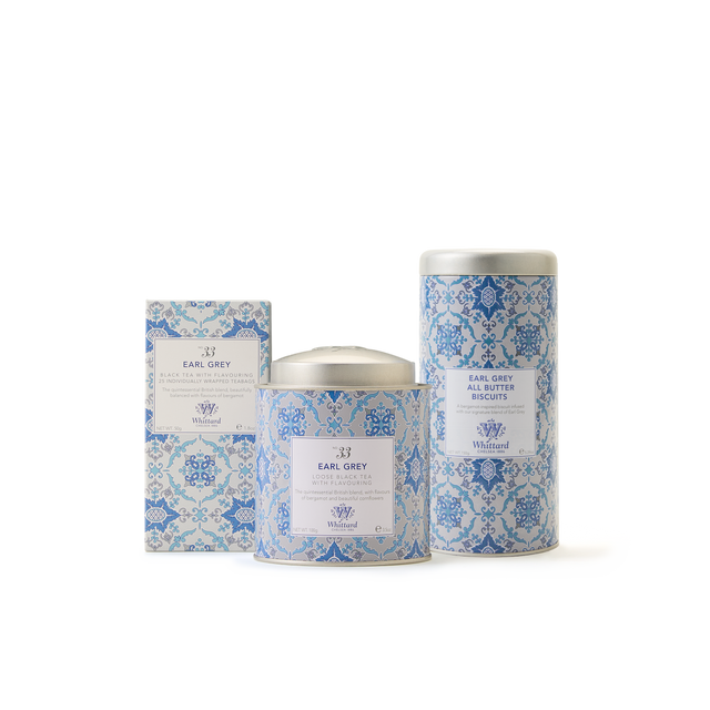 Three products from The Earl Grey Collection, each featuring light blue and white patterned packaging—a chocolate bar, a cylindrical tea tin, and a tall cylindrical biscuit tin—are displayed on a white background. Presented together as an elegant tea gift set, The Earl Grey Collection is ideal for savoring during afternoon tea or sharing with fellow Earl Grey enthusiasts.