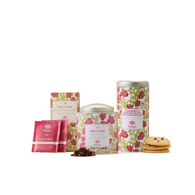 The English Rose Collection showcases a delightful assortment that includes floral-patterned tins, a box of English Rose tea, tea sachets, loose floral tea leaves, and two cookies stacked together—all beautifully displayed on a white background.