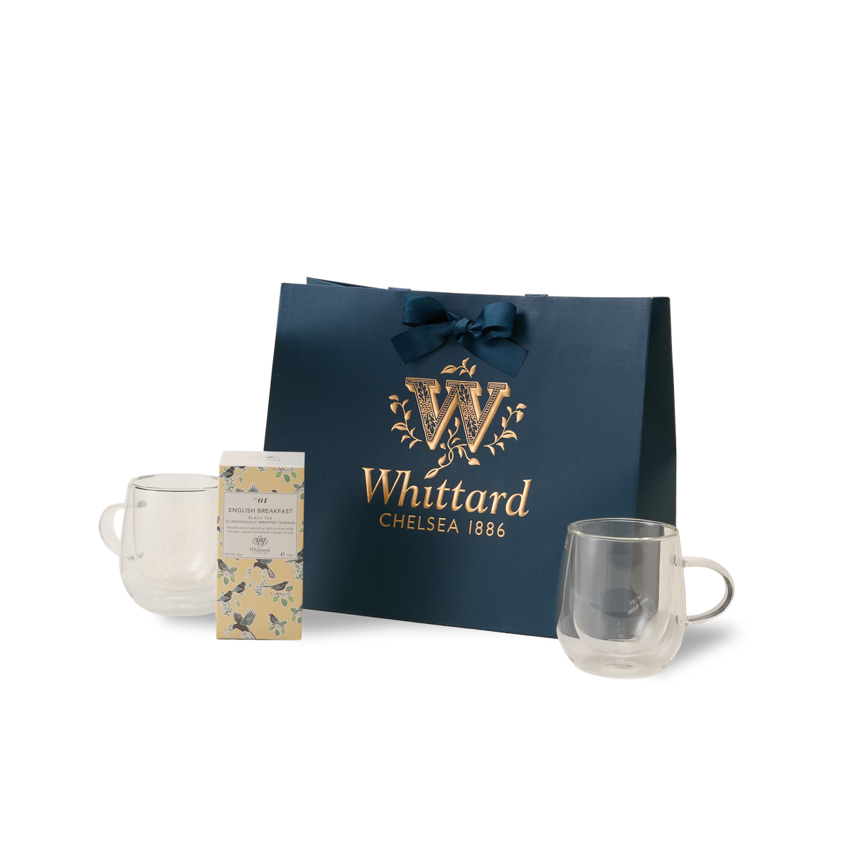 The Everyday Tea Gift Set features a navy blue Whittard Chelsea 1886 gift bag with a ribbon, two double-walled glass mugs, and a floral-designed box of English Breakfast tea containing individually wrapped teabags, all beautifully arranged against a white background.