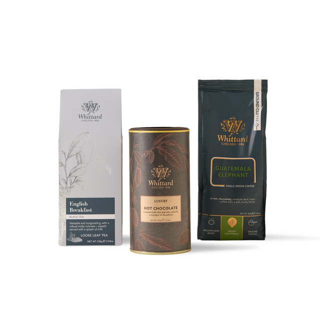 Three Whittard favourites—including their English Breakfast tea loose leaf box, Luxury Hot Chocolate canister, and Guatemala Elephant coffee bag—stand upright on a white background, perfect for sampling in your next The Bestsellers Subscription.