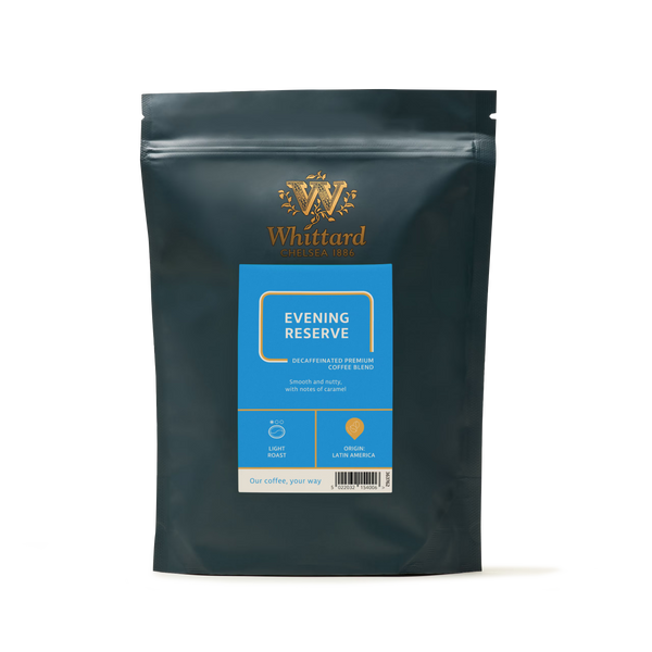 A dark green resealable bag of Evening Reserve Coffee from Whittard, ideal for enjoying in the evening, features a blue label indicating it is a light roast made from 100% Arabica beans sourced from Latin America. The Whittard logo is elegantly printed in gold at the top.