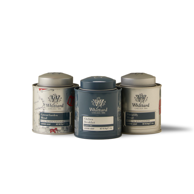 Three tins of Whittard loose leaf teas—General Garden, Chelsea Breakfast, and Piccadilly—are arranged side by side on a white background, creating The British Icons Mini Caddy Gift Box: a charming collectible trio and an ideal British tea gift set.