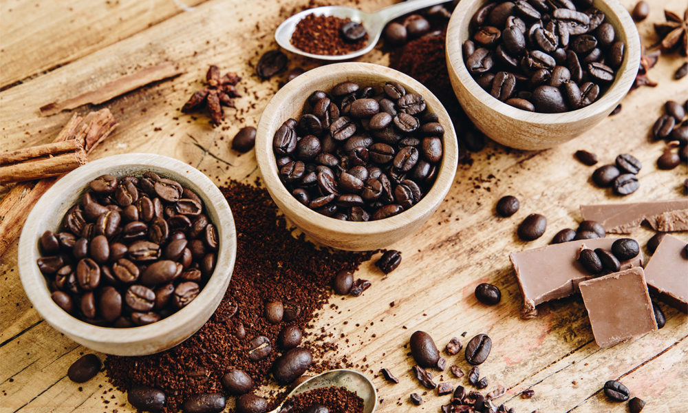 Whittard of Chelsea differing coffee bean roasts in bowls ranging from light roast to dark roast