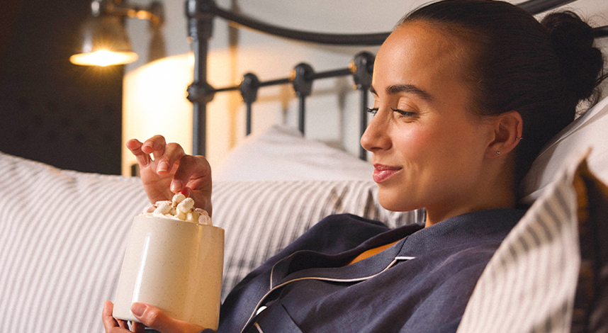 Woman in bed drinking Whittard Hot Chocolate
